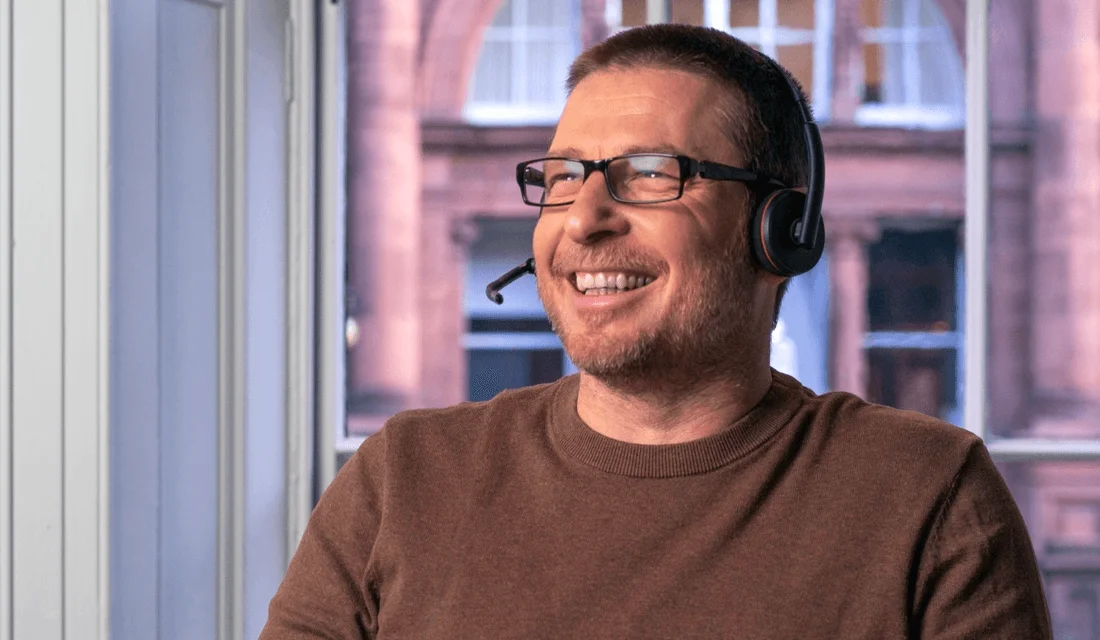 A support agent smiling on a call