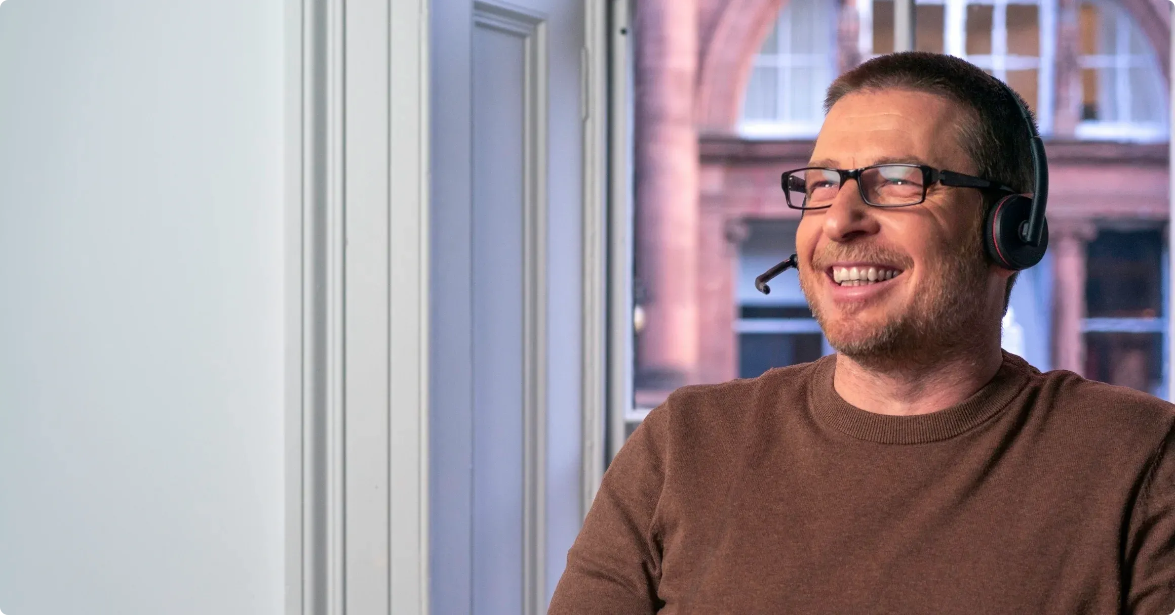 A support agent smiling on a call